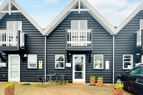 With a central location in the wonderful town of Blåvand and in walking distance to the kilometre long sandy beach, this high quality terraced house is built in a maritime style with exposed rafters and beams and furnished in a light Scandinavian sty...