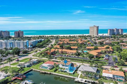 Welcome to Marco Island paradise! Live just one block from Residence Beach and the Gulf, this centrally located 4-bedroom, 4-bathroom home offers luxury living and convenience. Unwind in sophistication on the owner's level, accessible via an elevator...