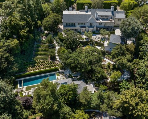 Graced by nearly an acre of incomparable, park-like grounds, gardens and you very own private vineyard, this legendary estate is privately enveloped by lush landscaping and double gates. A trophy property on one of the best streets through the presti...