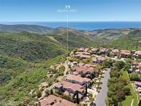 Designer home with 6 Bedrooms and views! Among the verdant hillsides and Pacific Ocean scenery this stylish Costa Azul residence is situated on the highly coveted front row within guard gated Pacific Ridge, the pinnacle point of Newport Coast. Showca...