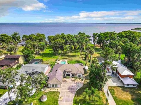 Welcome to 375 Magnolia Place, an exquisite 4-bedroom, 4-bathroom home including a large BONUS room and not one but TWO primary bedrooms with ensuites! This Lake Monroe waterfront home sits on over an acre of land in a NO HOA community! Lake Monroe i...