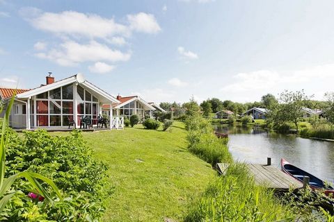 1st row. Luxurious Danish holiday home located directly on the lake with a view of the area in the Water and Landscape Park in Otterndorf. The house is i.a. furnished with panoramic windows, modern furniture, satellite TV and stereo with CD. In the b...