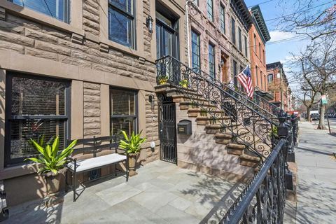 This exquisitely renovated four-level townhome is a stunning combination of old world magnificence and contemporary living. Impressive wide, true brownstone home with high ceilings and beautiful natural light throughout. The open concept garden level...
