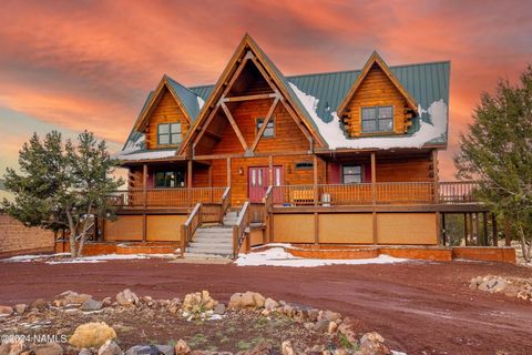 Discover tranquility and expansive beauty of the High Country. Stunning log home nestled on 5.03 acres secluded amidst towering juniper and pinon trees. A picturesque retreat boasts a charming wrap-around composite deck offering panoramic vistas, 3 b...