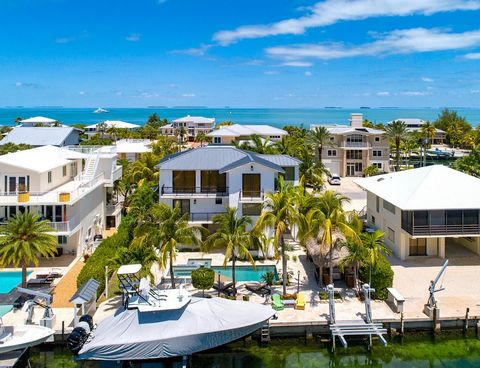 Welcome to Latitudes in Islamorada! This gorgeous 4 bedroom, 2.5 bathroom, 3 story home is located in the highly desirable 'live-work-play' community of Port Antigua on Lower Matecumbe Key in the Florida Keys. This home has it all - fantastic 360 vie...
