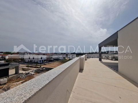 A house in a triplex with an attractive roof terrace of 129m2 is for sale in Vodice. Of the total terrace, part of 31m2 is covered, and it offers a beautiful view of the sea. The residential part of the house extends over 3 floors. On the ground floo...