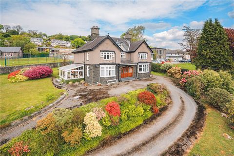 Penarlag is a substantial detached home dating back to 1927, constructed from traditional stone under a slated roof. Situated in an elevated and prominent position above the town of Dolgellau, it offers spectacular south-facing views of the Cader Idr...