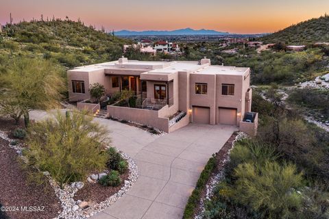 Custom home located in the gated Rockcliff community, near Sabino Canyon. This property features both stunning mountain and city views. Gourmet kitchen with alder cabinets, island with a prep sink, granite countertops and backsplash. Travertine floor...