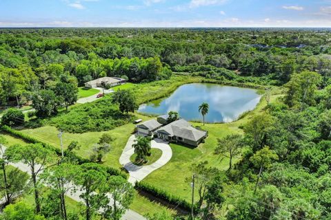 Looking for privacy to build your next home in Naples with your own private 1 acre lake and still live close to everything? Don't miss this Lakeside Estate set back 5 acres in Logan Woods! The current main house which could be renovated to your own p...
