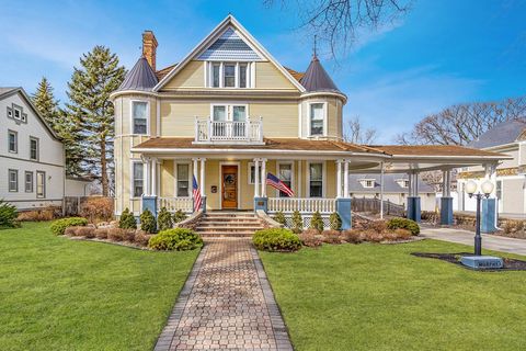 Located in the Near Southside Historic District of Grand Forks is this exquisitely charming 1901 Classical Revival Queen Anne home. You will be welcomed by a wrap-around porch, copper topped turrets and a porte cochere leading to a carriage house sty...