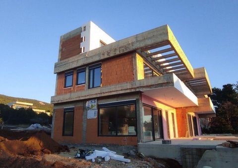 Two modern houses under construction in the second row to the sea in Stara Novalja, Pag! This three-part villas complex under construction is located in an extraordinary location with an incredible view of the sea and at a distance of 180m from the b...