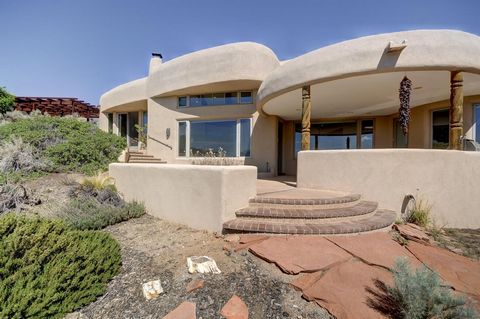 Enjoy the endless view in this elegant, roomy and peaceful home. Sitting high above Corrales, overlooking the Sandia's and the city lights is your new home with room for the extended family. 1.75 acres of natural beauty on a well and septic. Front an...