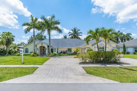 Step into your own private tropical oasis, where palm trees sway and ambiance abounds, offering unparalleled privacy. Upon arrival, the circular drive and grand double doors welcome you to your Heated Pool home, set amidst a fully fenced expansive ya...