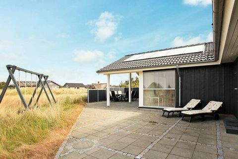 Approx. 100 metres from Blåvand beach you will find this holiday cottage. The living room is open plan with the kitchen and dining spaces. 2 bathrooms, one with whirlpool and sauna. Outside is the large terrace around the house, a small part of it is...