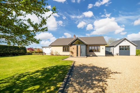 Stylish Single Storey Living. Nestled between three pretty villages with amenities close to hand, this welcoming family home is of sturdy 1960’s original build and has been renovated to pristine condition with thoughtful creativity. The peaceful ambi...