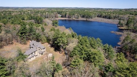 Offering views of Beaver Pond on 12+ private wooded acres in North Beverly. This master craftsman estate feels delightfully secluded, but enjoys a location near commuter rail, major routes, shopping, beaches, and more. The stone and wood facade is re...